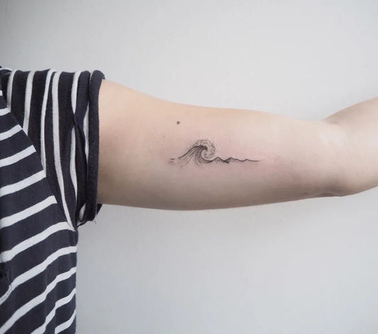 Small Fine Line Wave Tattoo on Women Arm by @whitewhaleamsterdam
