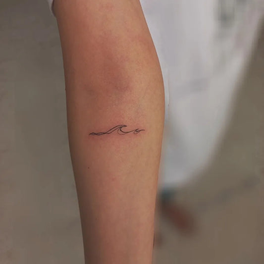 Small Fine Line Wave Tattoo on Women Forearm by @rey_tattooo