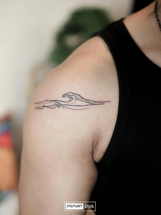 Small Fine Line Wave Tattoo on Women Shoulder by @memorystick.tattoo