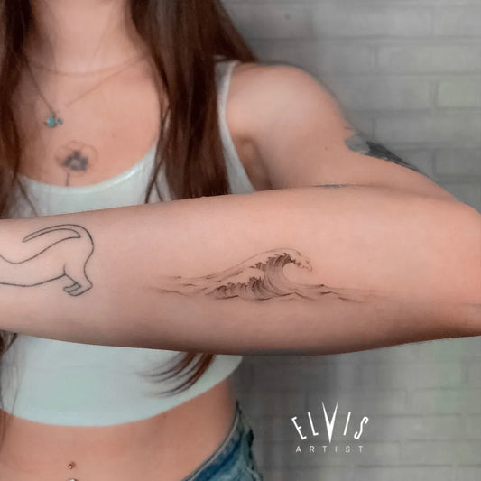 Small Fine Line Wave and Dog Tattoo on Women Arm by @elvis_pachamamatattoo