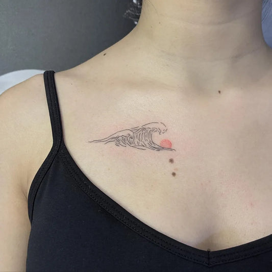 Small Fine Line Wave and Sun Tattoo on Women Collarbone by @takeda.ink