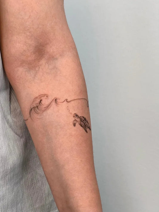 Small Fine Line Wave and Turtle Tattoo on Women Arm by @mr.morra.ttt