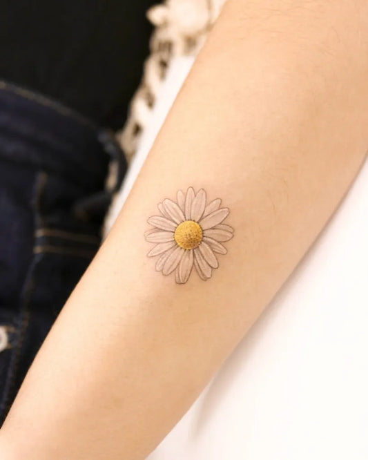 Small Fine Line White Daisy Tattoo on Women Arm by @nemo.tattoo