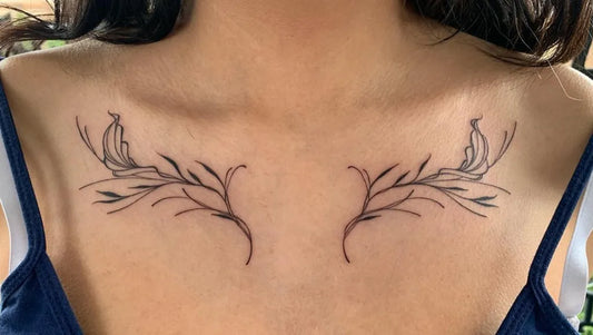 Small Fine Line Wings Tattoo on Women Collarbone by @grackle.kin