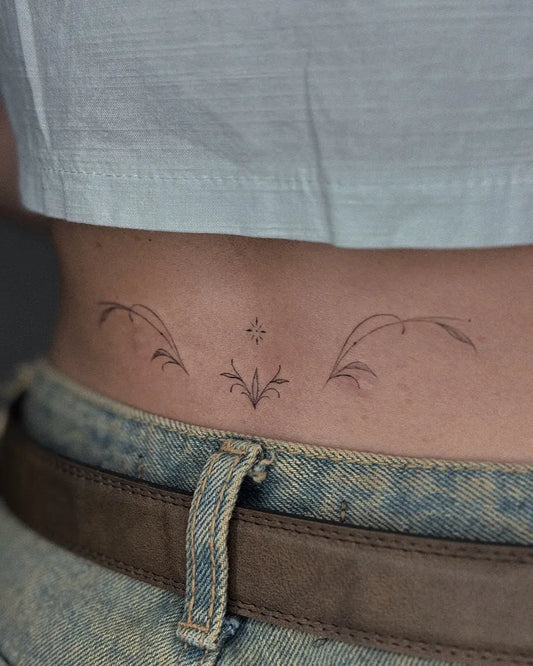 Small Fine Line Wings and Star Tattoo on Women Lower Back by @narot_6.49oz