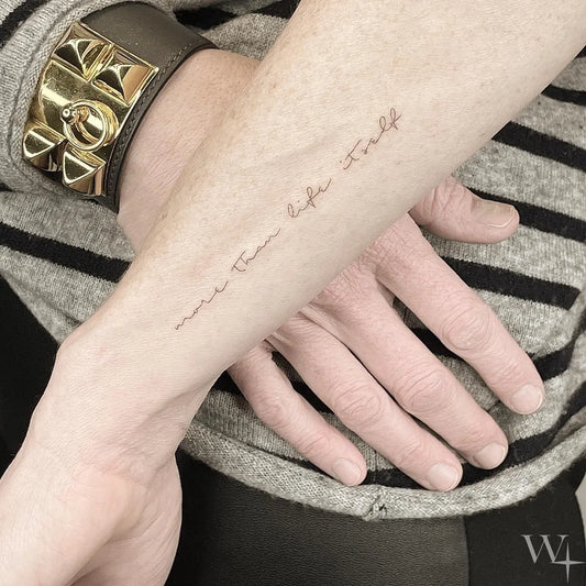 Small Fine Line Word Quote Tattoo on Men Forearm by @west4tattoo