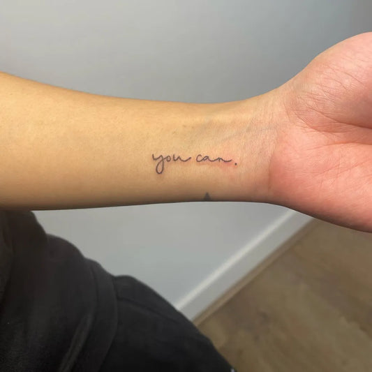 Small Fine Line Word Quote Tattoo on Women Wrist by @minkxbeautyink.melbourne