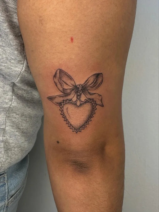 Small FineLine Bow Heart on Women Arm Tattoo by @valvntin