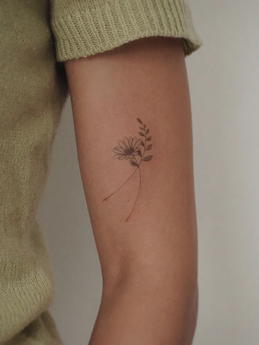 Small FineLine Daisy and Fern Women Arm by @tattoowithkay