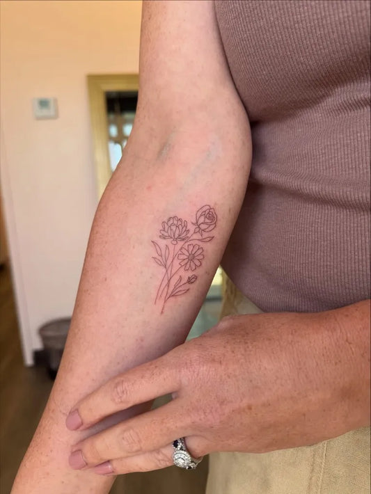 Small FineLine DaisyCluster on Women Arm Flower Tattoo by @ever.inktattoo