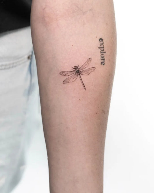 Small FineLine Dragonfly and Explore Text on Women Arm Tattoo by @izzet_tattoos