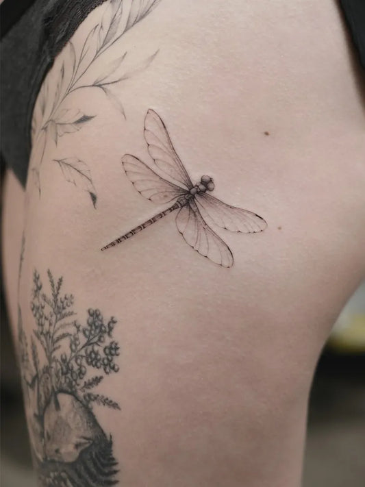 Small FineLine Dragonfly and Flowers on Women Thigh Tattoo by @fleur.dencre