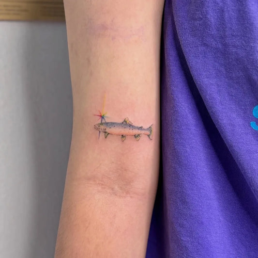 Small FineLine Fish Tattoo on Women Arm by @tatt.phobia