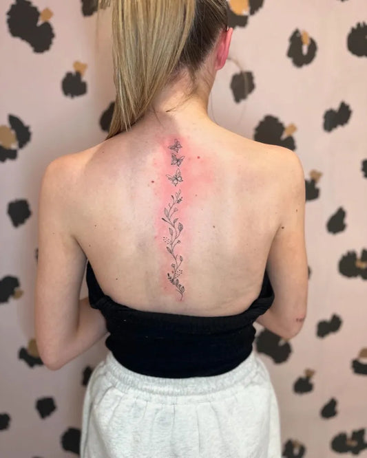 Small FineLine Flowers Leaves on Women Spine Tattoo by @baby_ink_