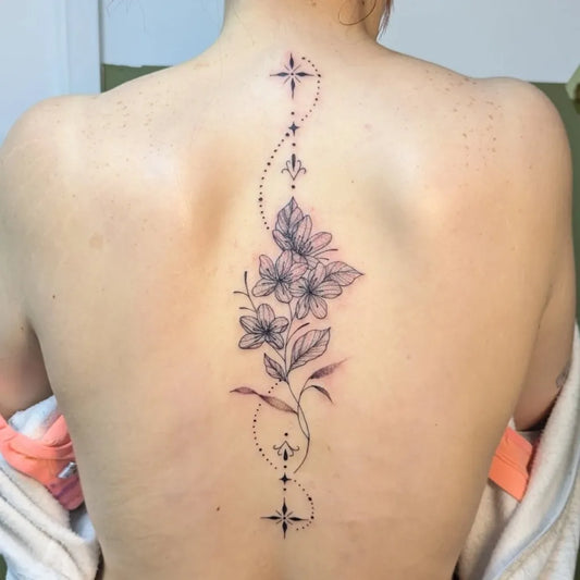Small FineLine Flowers Stars Spine on Women Tattoo by @chelly_tattoo