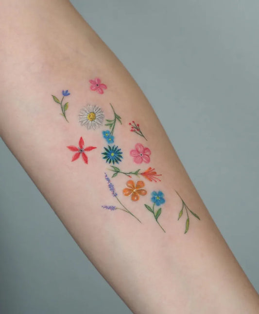 Small FineLine Flowers and Leaves on Women Arm Flower Tattoo by @ozgecanoglu