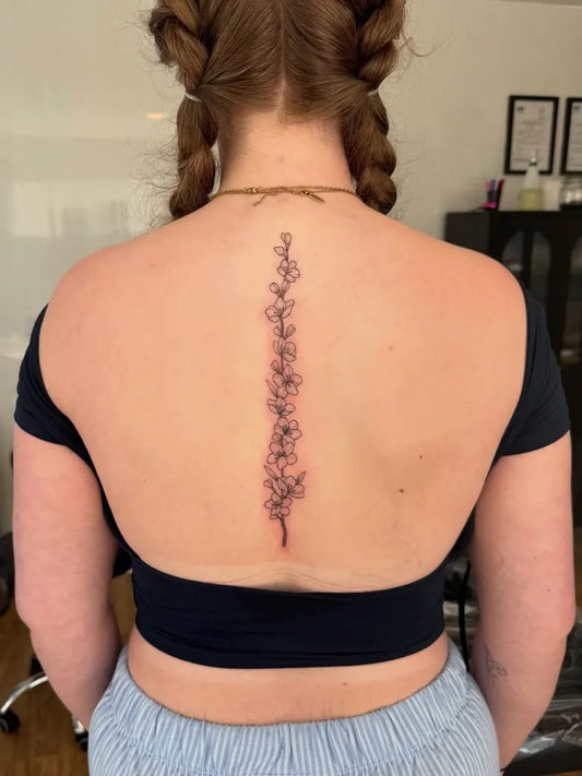 Small FineLine FoxgloveFlowers on Women Spine Tattoo by @josietattoos