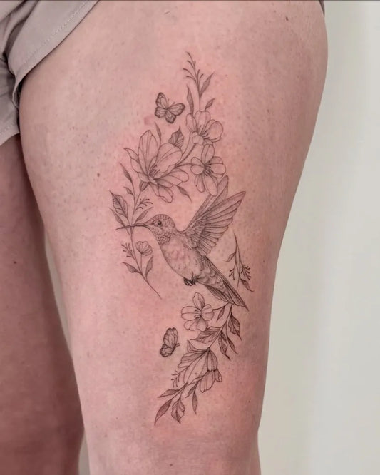 Small FineLine Hummingbird Flowers Butterflies on Women Thigh Tattoo by @devinevansart