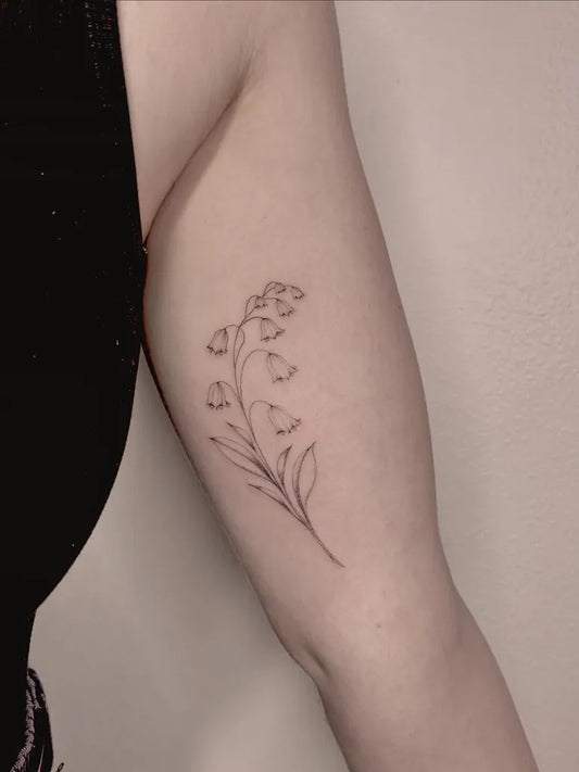 Small FineLine Lily of the Valley on Women Arm Tattoo by @daria.inkwaves