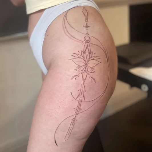 Small FineLine Lotus Sword on Women Thigh Tattoo by @romileyink