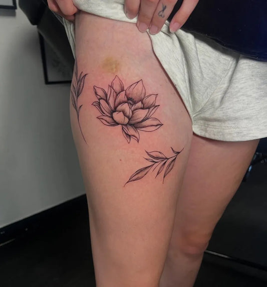 Small FineLine Lotus and Leaves on Women Thigh Tattoo by @sineadparkin_tattoos
