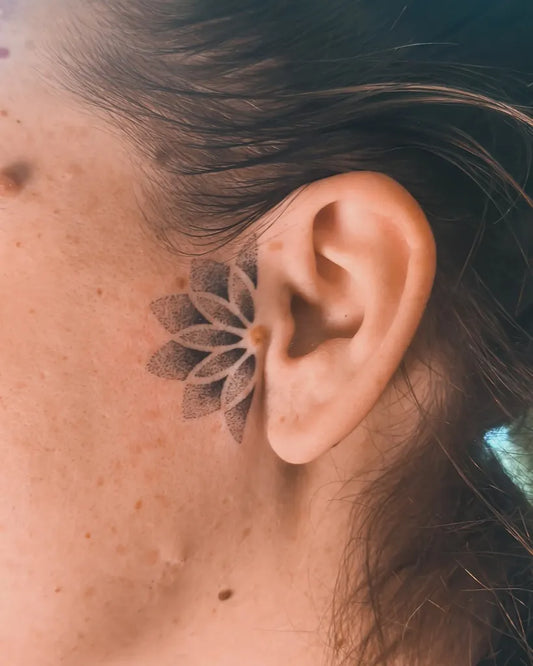 Small FineLine Lotus on Women Ear Tattoo by @encorps.studio