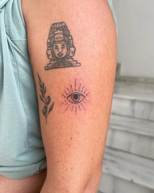 Small FineLine MayanMaskRadiantEye on Women Arm Tattoo by @artanitattoos
