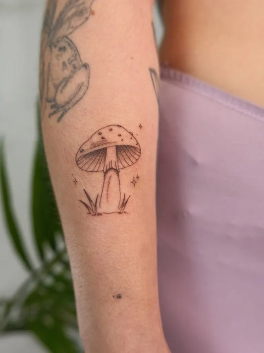 Small FineLine Mushroom with Stars and Grass on Women Arm Tattoo by @phoebetattoos