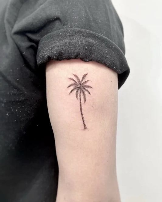 Small FineLine Palm Tree Tattoo on Women Arm by @daytwelvetattoostudio