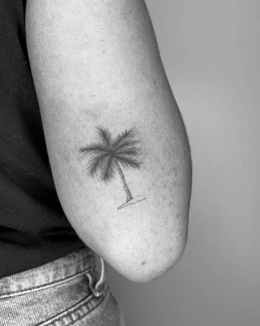 Small FineLine Palm Tree Tattoo on Women Upper Arm by @anatzz.tattoo
