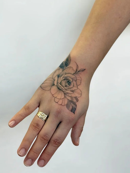 Small FineLine Rose Leaves on Women Wrist Tattoo by @inkbunnystudio