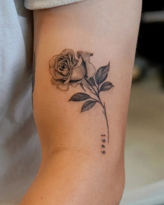 Small FineLine Rose with 1999 on Women Arm Tattoo by @zeetattoo