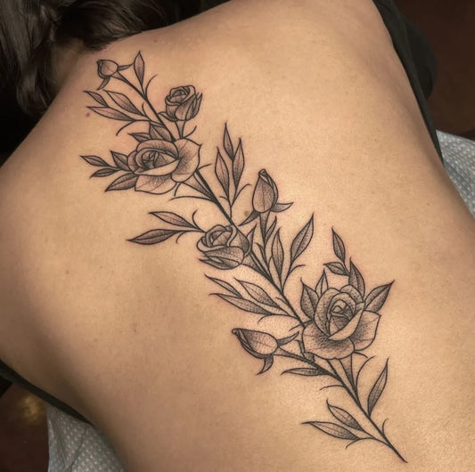 Small FineLine RoseBranch on Women Spine Tattoo by @fifthfingerstudio