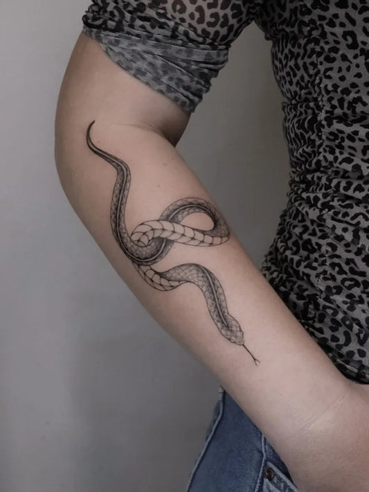Small FineLine Snake on Women Arm Tattoo by @justine.tattoo