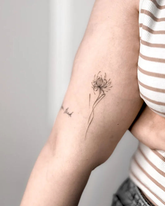 Small FineLine Spider Lily black Tattoo on Women Arm by @zeetattooo