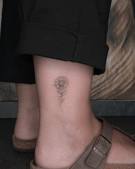 Small FineLine Sunflower on Women Ankle Tattoo by @noemiculottattoo