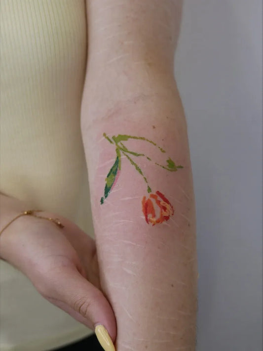 Small FineLine Tulip Tattoo on Women Arm by @tattooist_dang