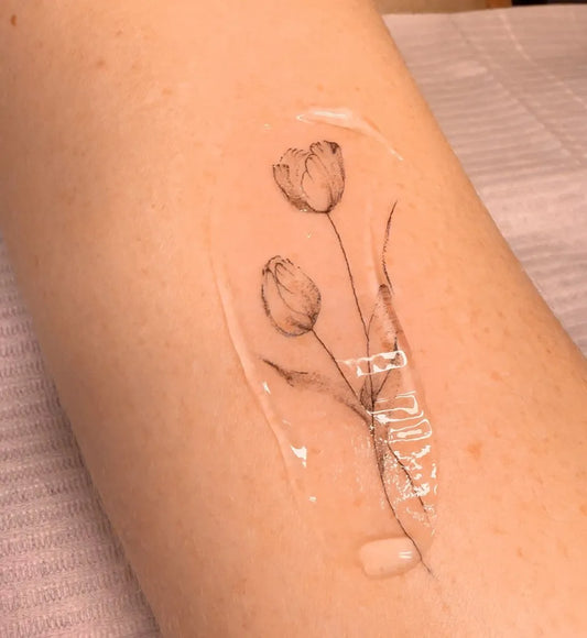 Small FineLine Two Tulips Tattoo on Women Forearm by @elizatattooamsterdam