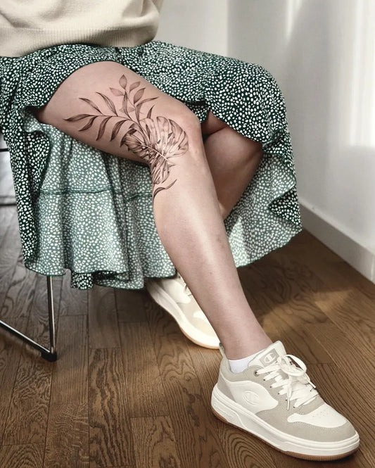 Small Floral Branch Leaf on Women Leg Tattoo by @franchesca_tattoo