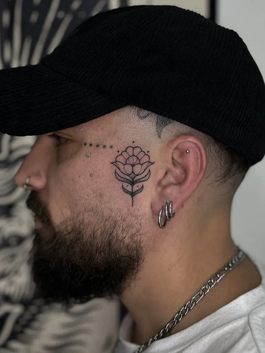 Small Floral Flower on Men Face Tattoo by @konna_x_tattoo