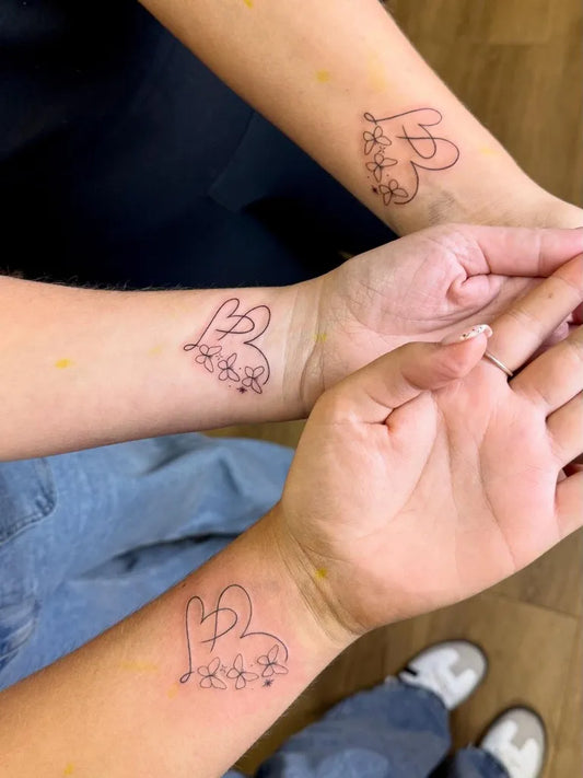 Small Floral Heart on Friends Wrist Matching Tattoo by @nicole.tattoos_
