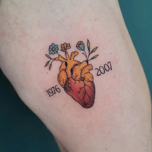 Small Floral Heart with Flowers on Women Arm Tattoo by @chanell_tattooer