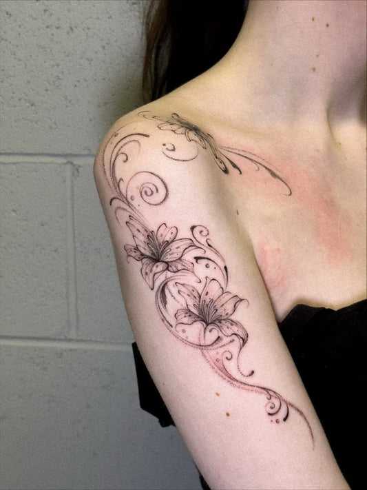 Small Floral Lily and Vines on Women Shoulder Flower Tattoo by @itszuzutatattoo