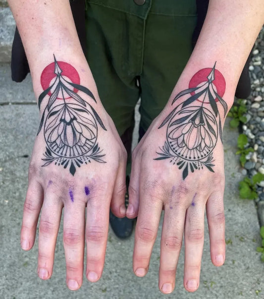 Small Floral Mandala Symmetrical Flowers with Red Accents on Women Wrists Tattoo by @linzihungerfordtattoos