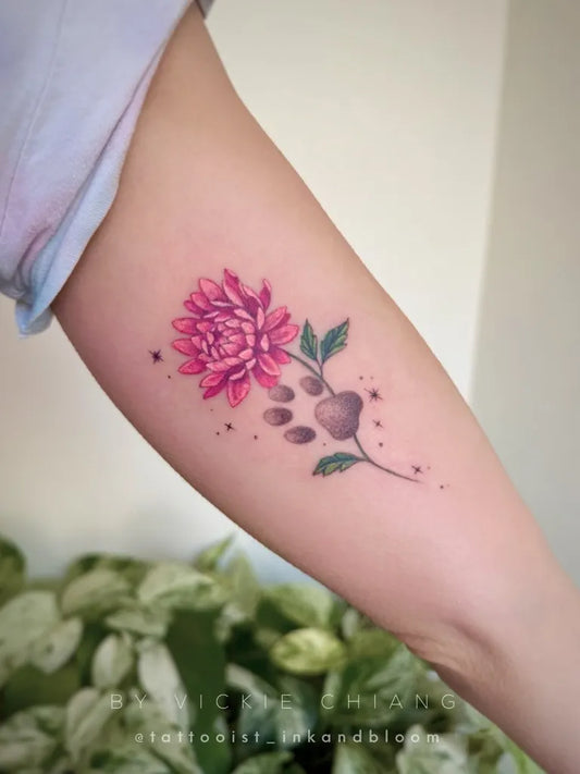 Small Floral Paw Print Dahlia Tattoo on Women Arm by @tattooist_inkandbloom