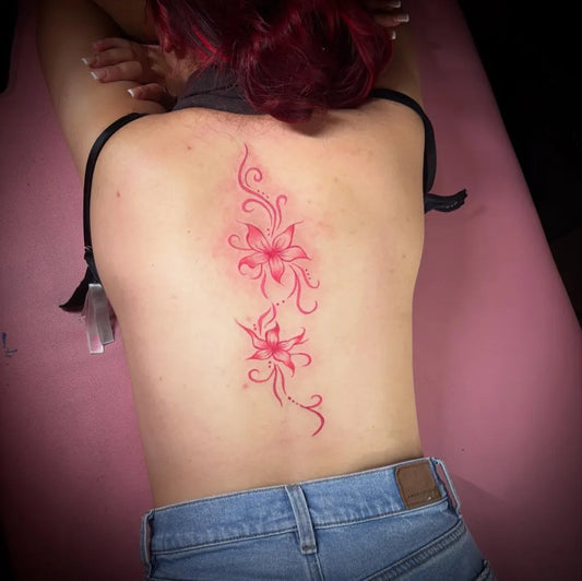 Small Floral Red Flowers and Vines on Women Spine Tattoo by @tattoosby.jadance