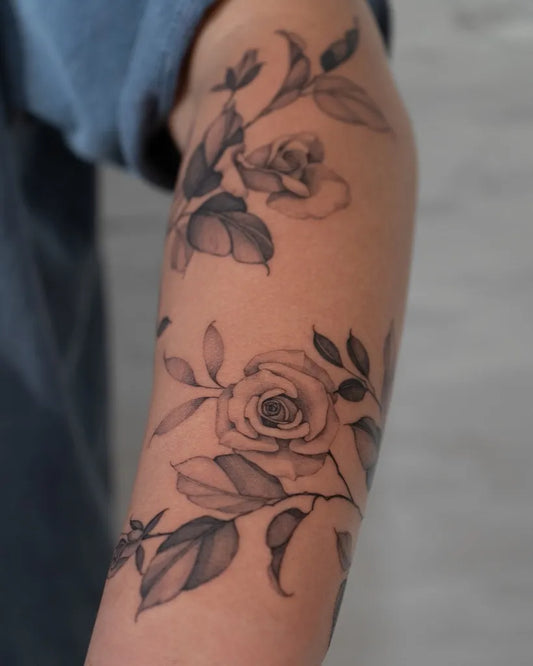 Small Floral Rose Leaves on Women Arm Tattoo by @lilyblu.ink