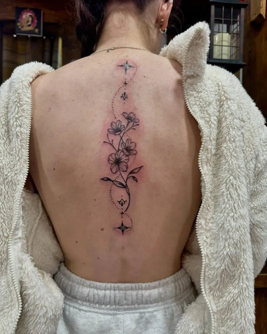Small Floral Vine with Stars on Women Spine Tattoo by @black.pearltattooparlour