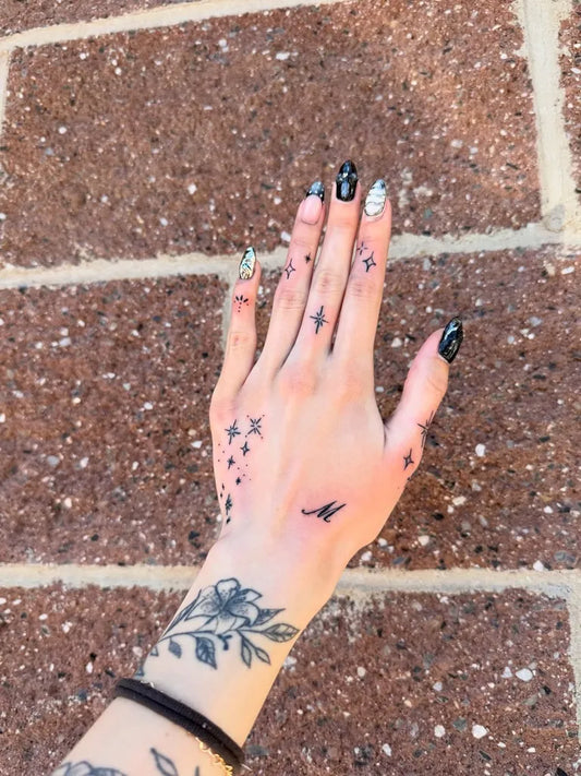Small Floral and Stars Rose with Stars on Women Hand Tattoo by @444.inkandbeauty