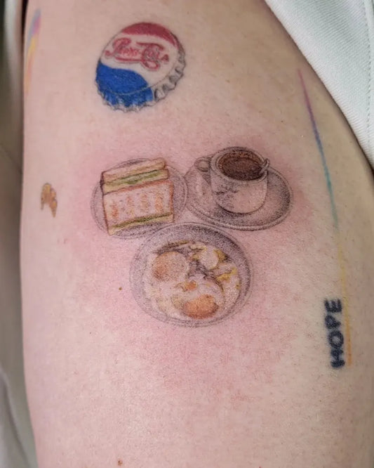 Small Food Toast Eggs Coffee on Women Arm Tattoo by @jud.tattoos